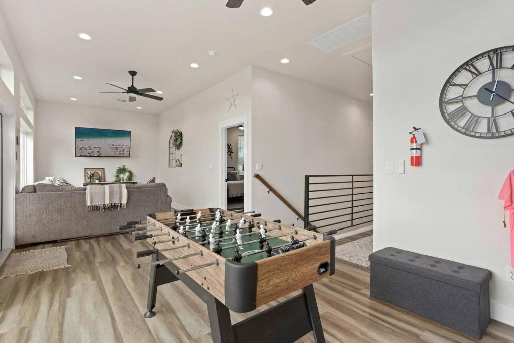 a living room with a foos ball at Riverscape Townhome A, Just Steps Gruene Hall in Gruene