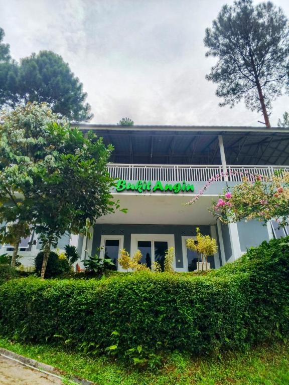 a building with a sign on the side of it at Alvaro Resort Bukit Angin in Ciguntur