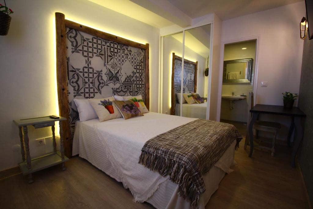 um quarto com uma cama grande e uma grande cabeceira. em Las Casitas em Santander