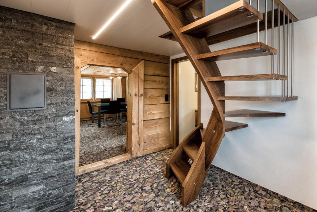 escalera de madera en una habitación con escritorio en Hof Mazenau, en Appenzell