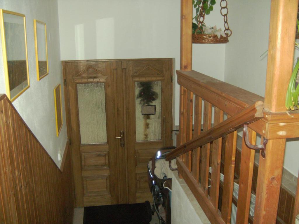 a hallway with a wooden door and a stair case at Ubytování Maxa in Špičák