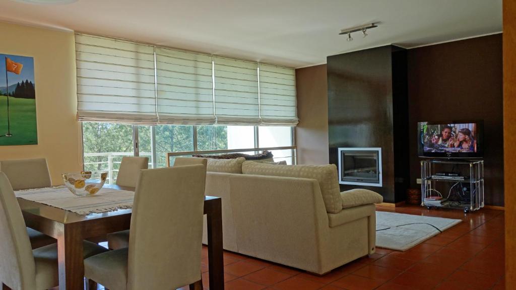 a living room with a couch and a table at Hole 14 - Ponte de Lima in Ponte de Lima