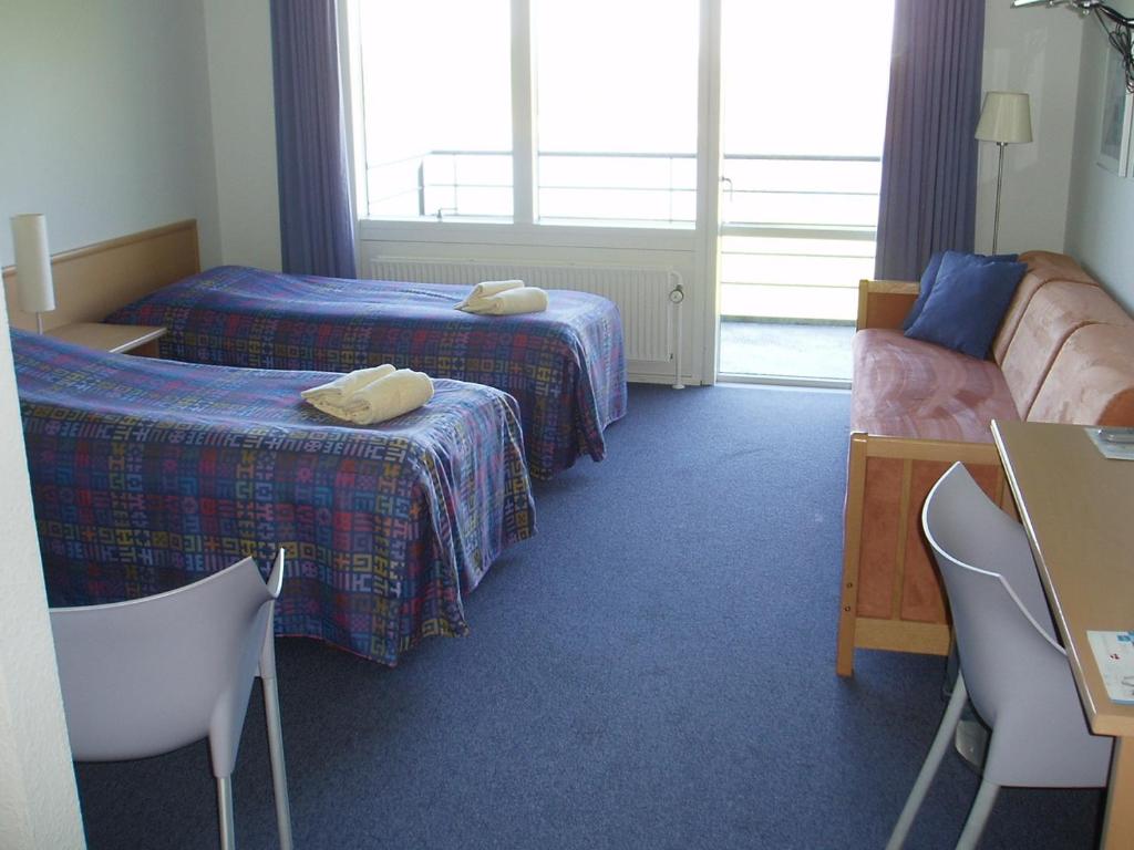 Postel nebo postele na pokoji v ubytování Hotel Nordborg Sø