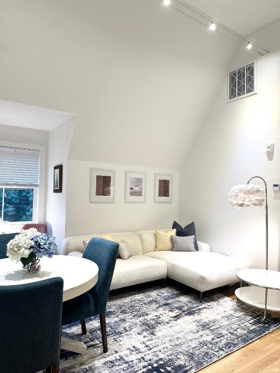 a living room with a white couch and a table at 2BR Unit near Brown & RISD with Free Parking, Full Kitchen in Providence