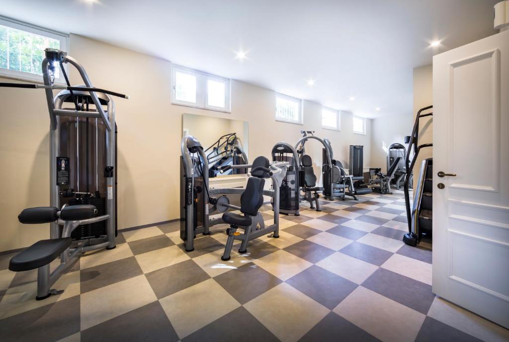 a gym with tread machines and a checkered floor at Hotel Bellevue - Liburnia in Opatija