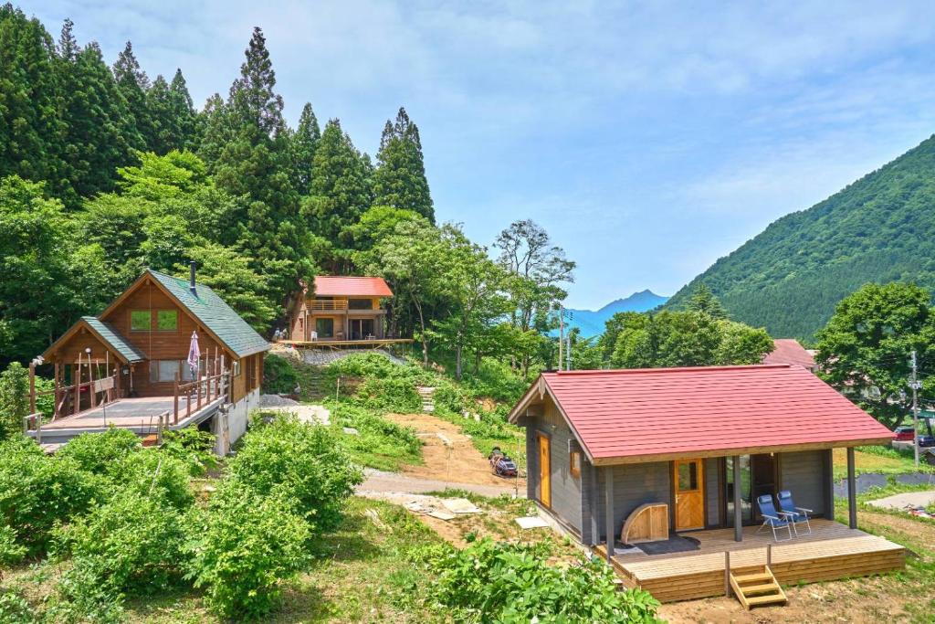 an aerial view of a house with a red roof at ペルセウス座流星群の体験 Villa Dottaru 土樽の自然に囲まれた大人の秘密基地 in Yuzawa