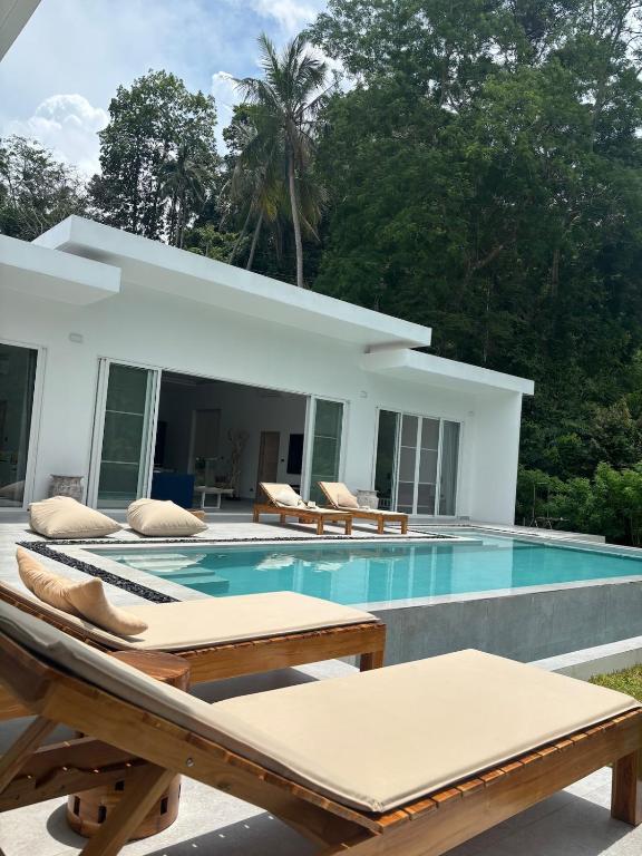 a villa with a swimming pool and a house at Villa Lamai 4 bedrooms in Koh Samui 