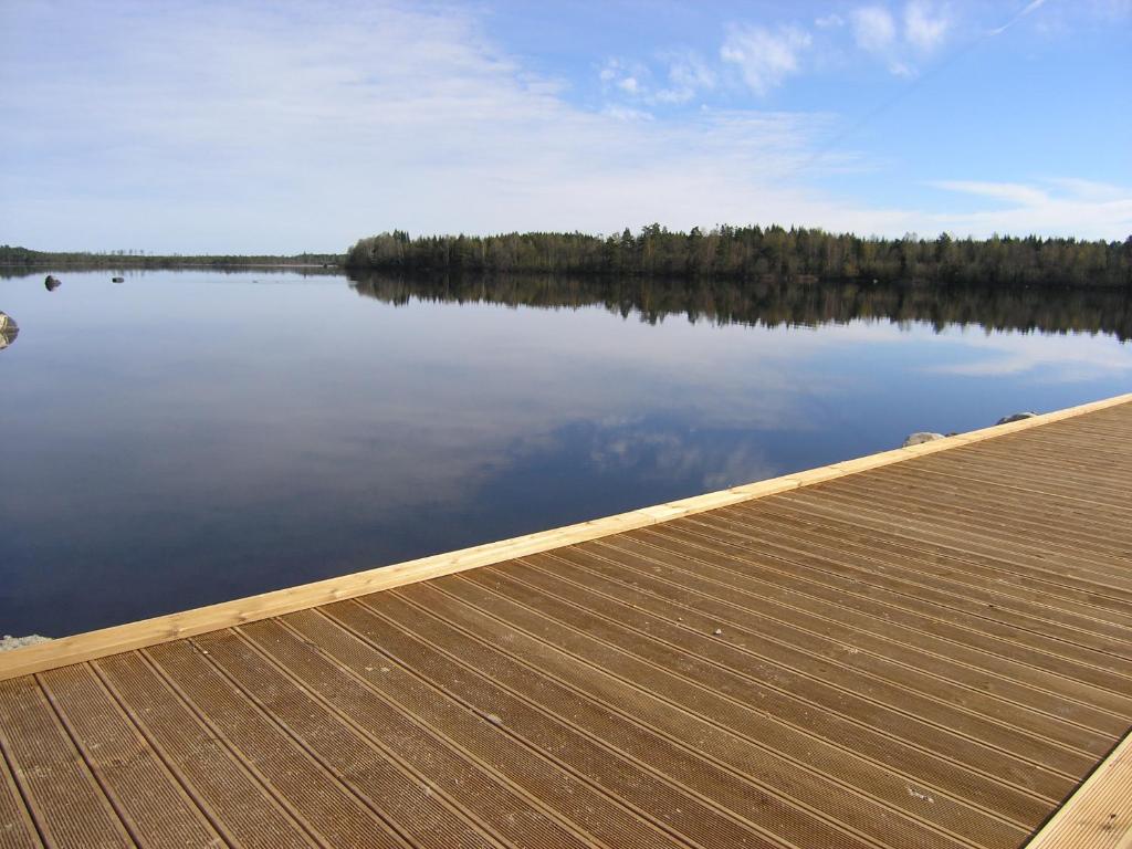 a dock with a view of a lake at B & B Flattinge Fritidshus in Vittaryd