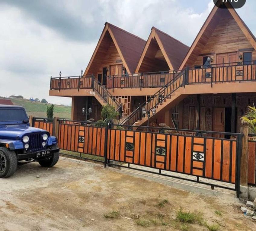 a house with a truck parked in front of it at Villa Della Puncak 2000 Siosar in Talunkota
