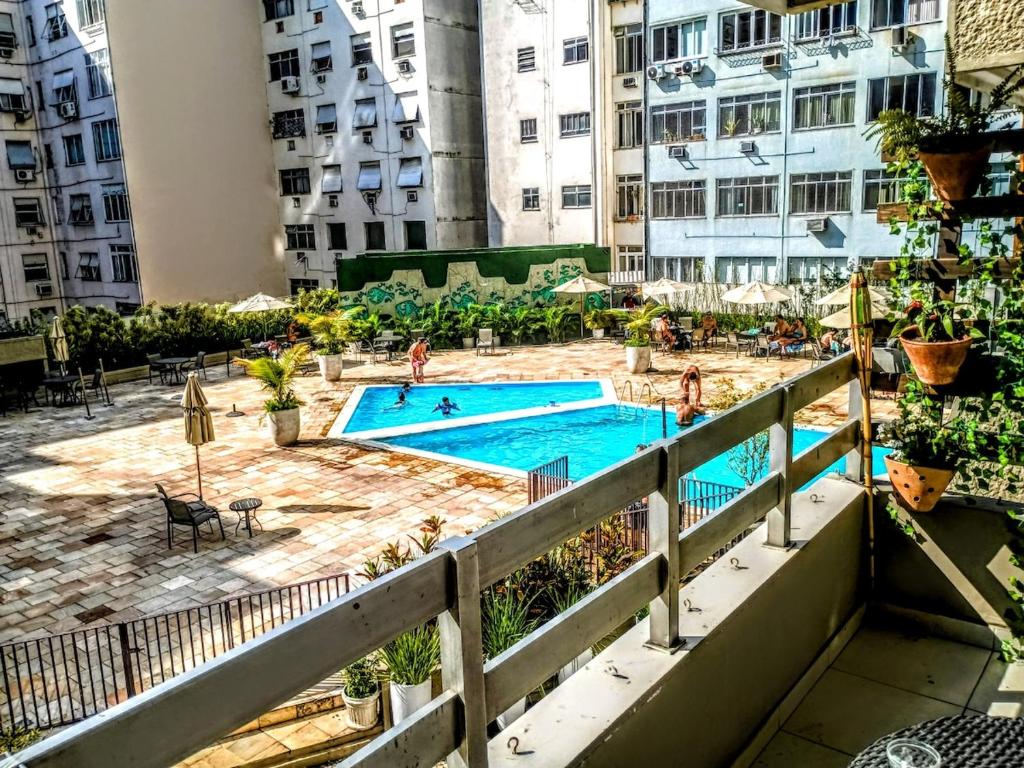 a view of a pool from a balcony of a apartment at Apart Novidade do verao in Rio de Janeiro