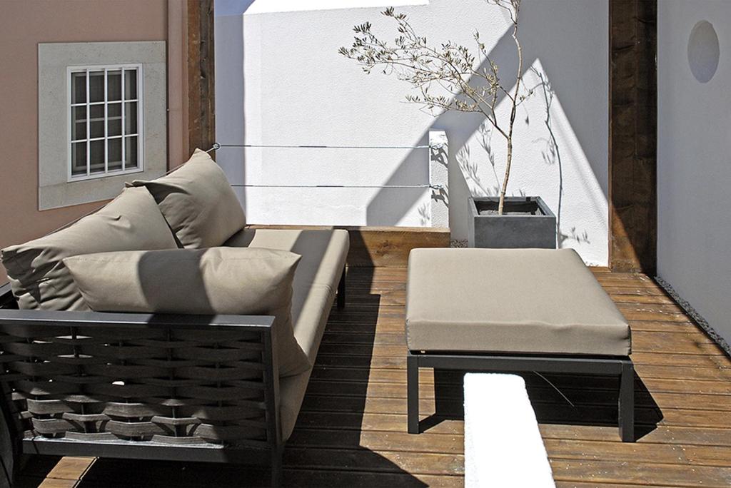 a living room with a couch and a table at Casa Miradouro Apartments in Setúbal