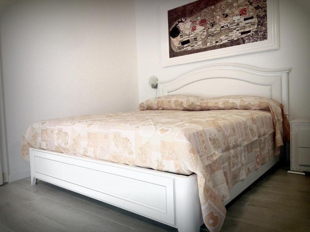 a bedroom with a bed with a comforter on it at B&B San Francesco in Taranto