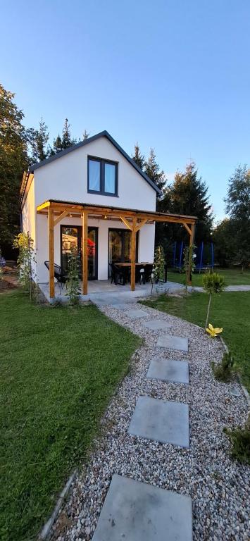 a house with a stone path in front of it at Domek KAMA in Giżycko