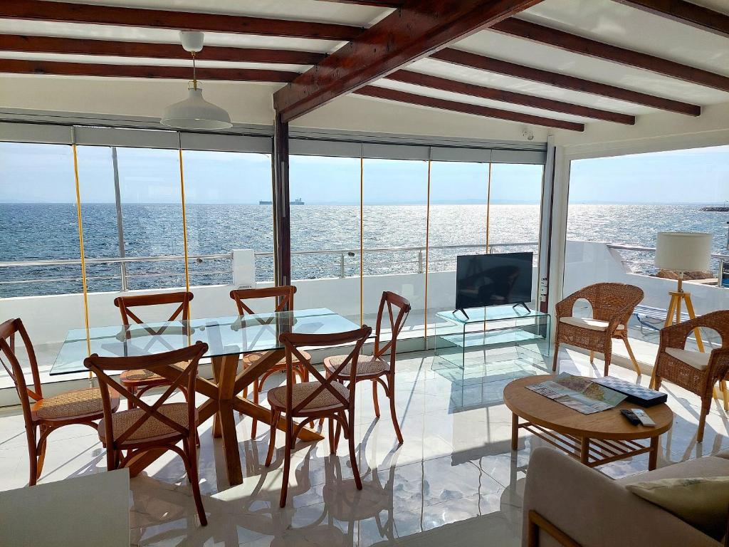 a dining room with a view of the ocean at Seafront Panorama Penthouse in Chios