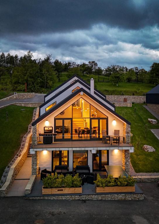 a large house with a lot of windows at Altfel Bran Chalet 2 in Bran