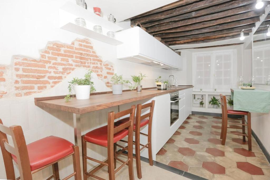 a kitchen with a wooden table and chairs at Ca' du Pitta in Genova