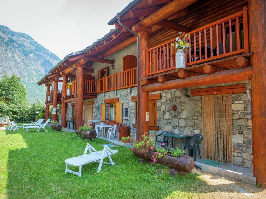 a house with a bench in front of it at A Cozy Alpine Retreat in Antey-Saint-André