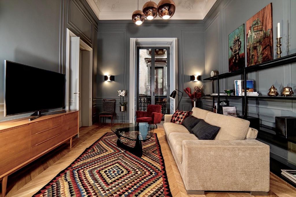 a living room with a couch and a flat screen tv at Luxury apartment in the center of Catania in Catania