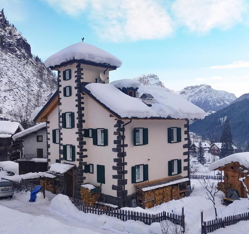 a building with snow on top of it at La Casa dei Botiri in Rocca Pietore