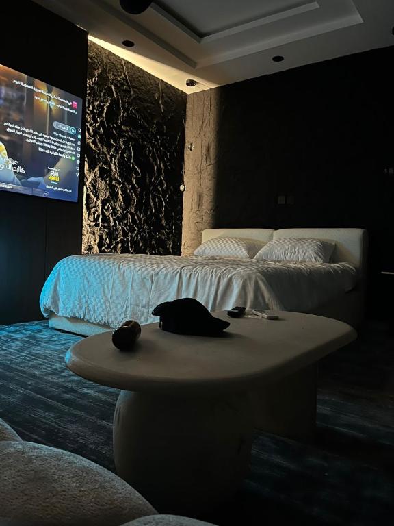 a room with two beds and a table with a screen at Safety house in Tabuk