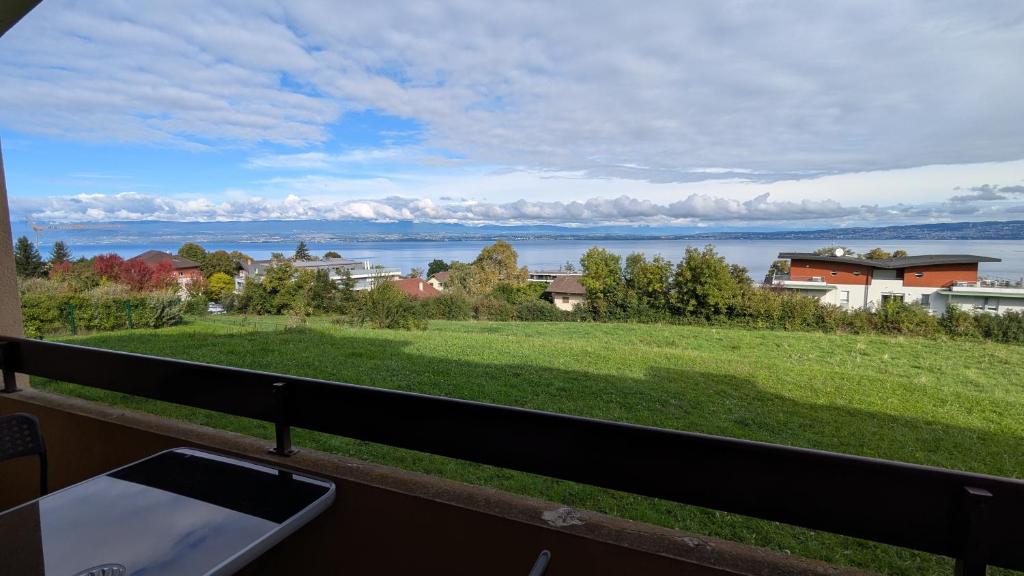 a view of the water from the balcony of a house at Le Panoramic Evian in Évian-les-Bains