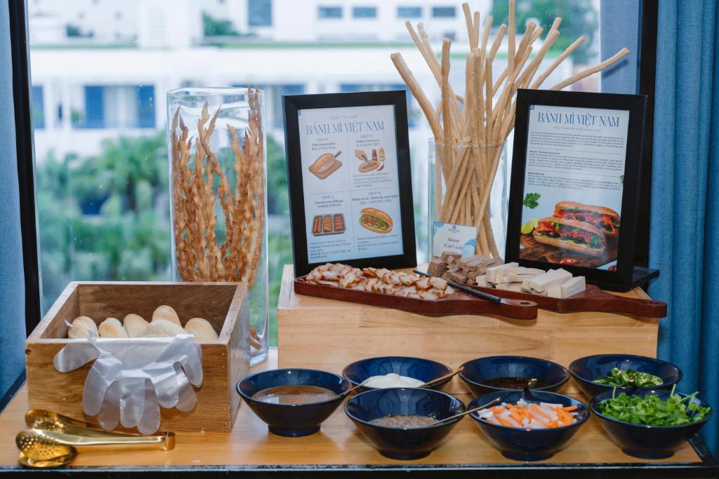 A window-side breakfast station with Vietnamese breads, toppings and bowls.
