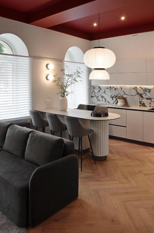 a living room with a table and a couch at Violet Lux Apartment in Daugavpils