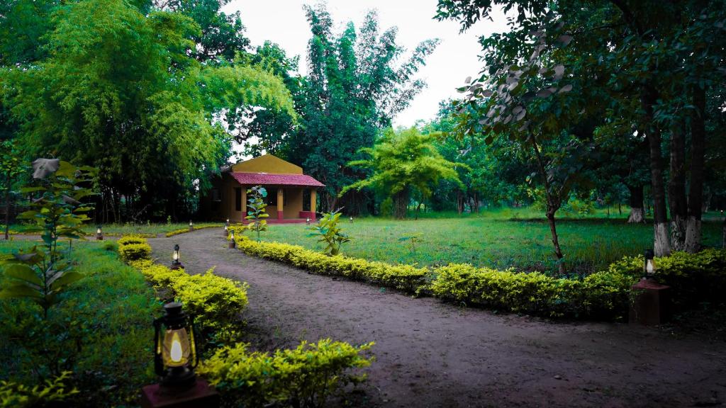 a path leading to a gazebo in a park at Wild Haven Resort Bandhavgarh in Tāla