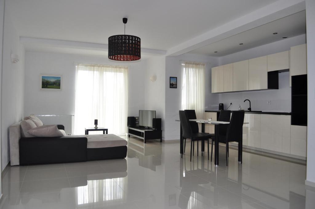 a living room with a bed and a kitchen at Apartament Scorpion Modlin in Czosnów