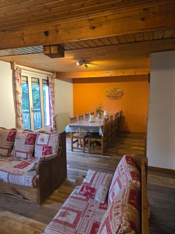 a living room with couches and a table and a dining room at Gîte Le Lac à La Dame in Foncine-le-Bas