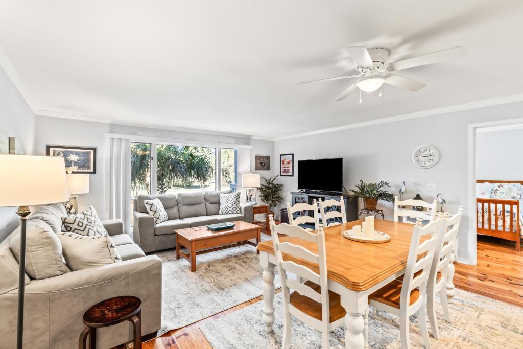 a living room with a table and a couch at Lagoon Villa 25 - Heart of Wild Dunes, Quick Walk to Beach in Isle of Palms