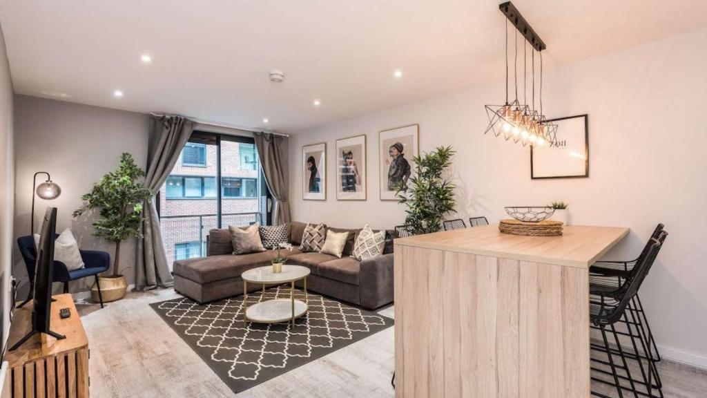a living room with a couch and a table at Stylish Liverpool Apartment with Parking & Balcony in Liverpool