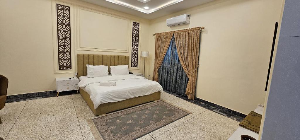 a bedroom with a bed and a window at White House Karachi in Karachi