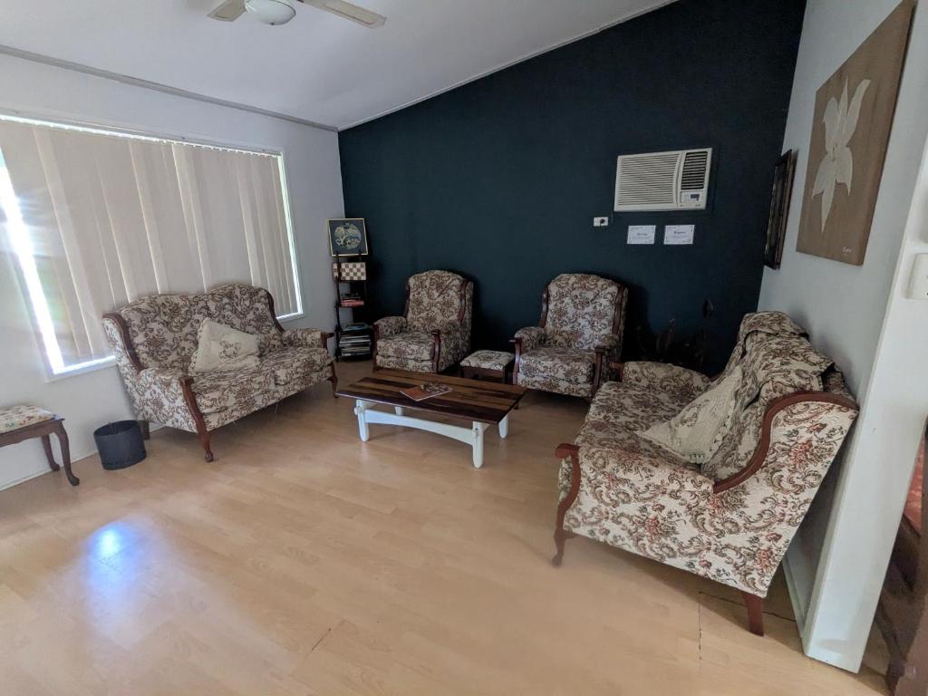 un salon avec trois chaises et une table basse dans l'établissement The Cottage on George Street, à Jarrahdale