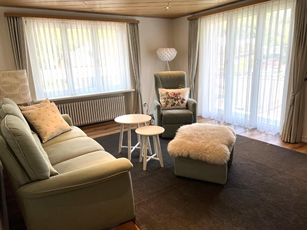 a living room with a couch and a chair and a table at Ferienwohnung Michels in Realp