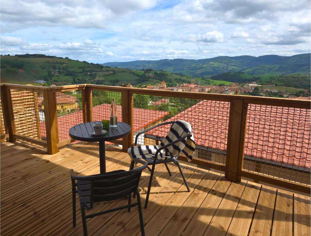 a balcony with a table and chairs and a view at Tiny d'Monts in Brullioles