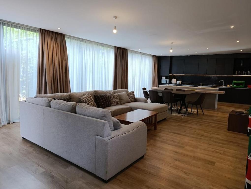 a living room with a couch and a table at Ineza Runda luxury exclusive in Kiambu