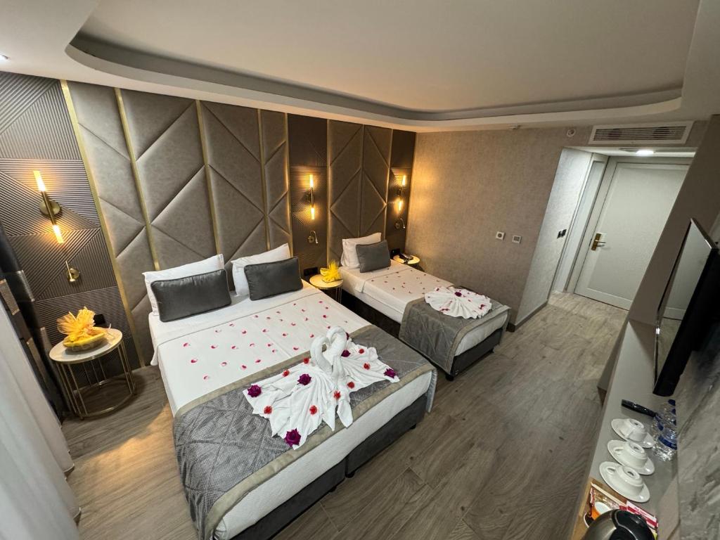 a hotel room with two beds and a table at Elysia Hotel in Istanbul