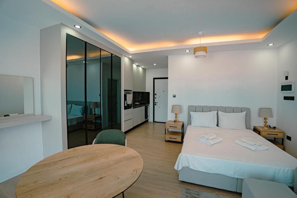 a bedroom with a bed and a table and chair at Fabulous Studio at stunning Palmera Resort on Medditerranean coast in Karavas