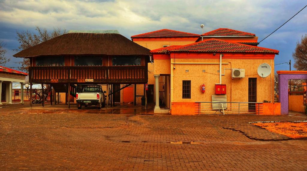 a building with a truck parked in front of it at Phumelela Guesthouse in Trompsburg