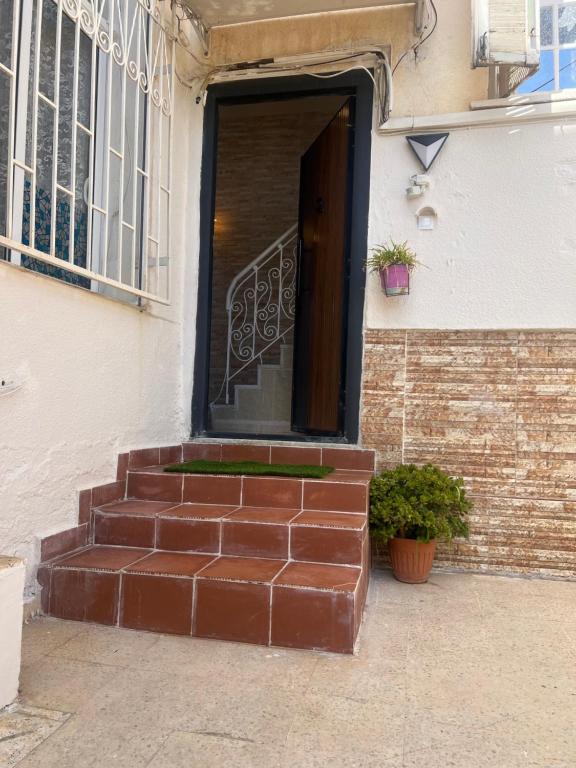 a brick stairway leading to a door of a building at Le mistral in Sidi MʼHamed