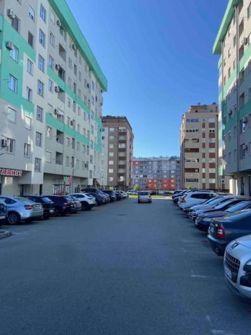 a parking lot with cars parked next to tall buildings at Lake View EIA in Lukavica