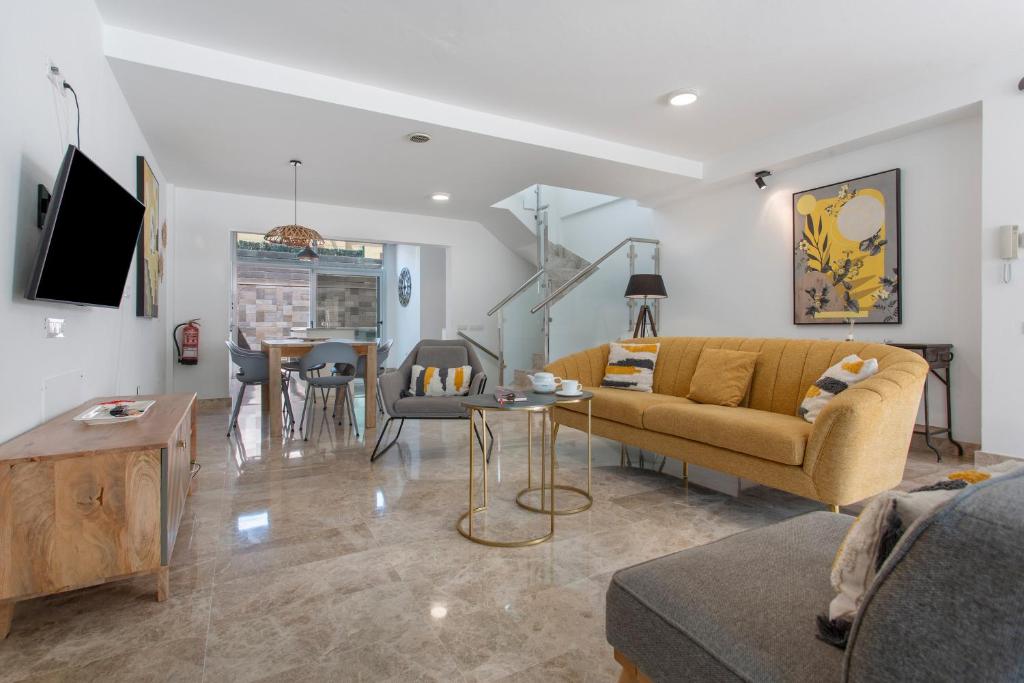 a living room with a couch and a table at Casa Alicia in Corralejo