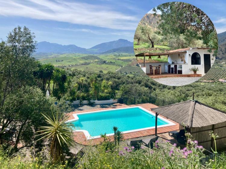 a pool in front of a house with a mountain at Casa del Sueño in Alora