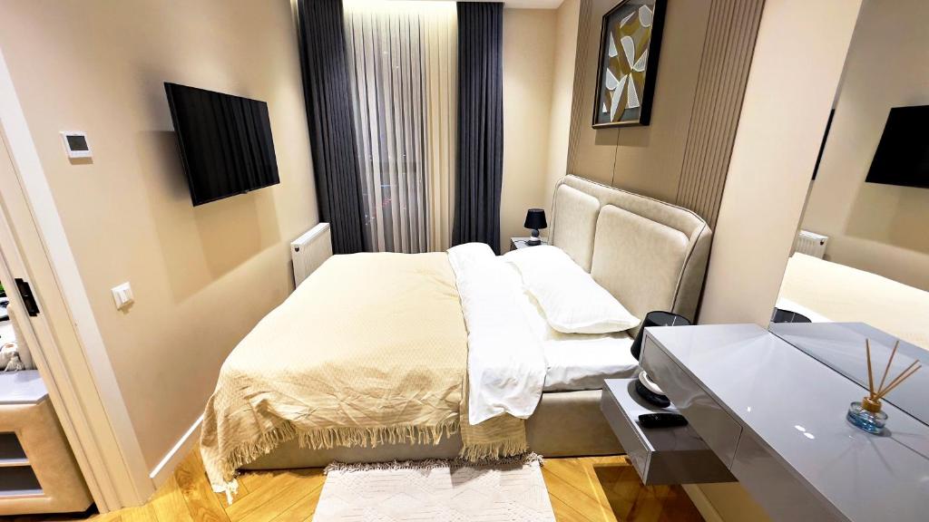 a small room with a bed and a desk at Nest One Parkside in Tashkent