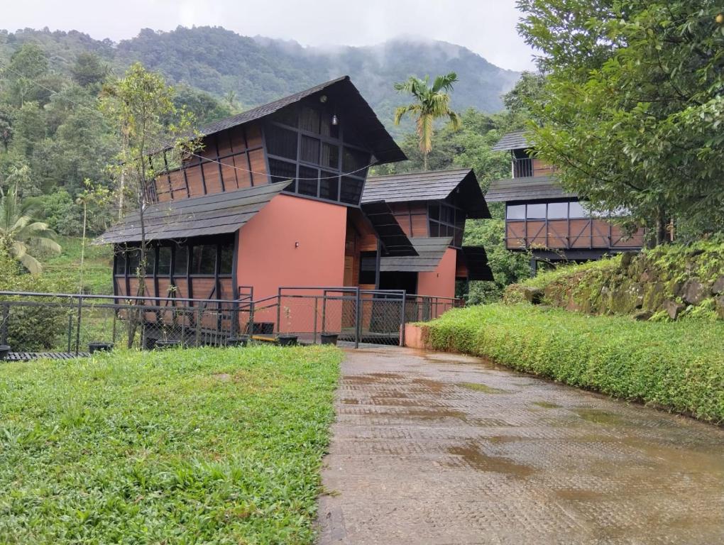 a house with a pathway in front of it at Moonrise Valley Freshwave Resorts Pvt Ltd in Koroth