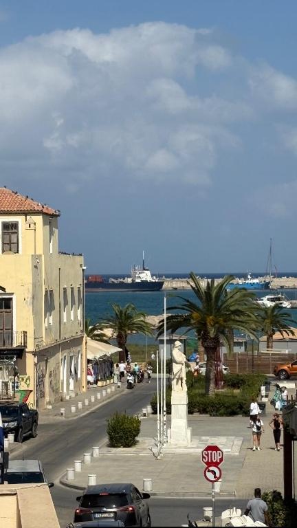 a city street with a stop sign and palm trees at Kanakakis home in Rethymno