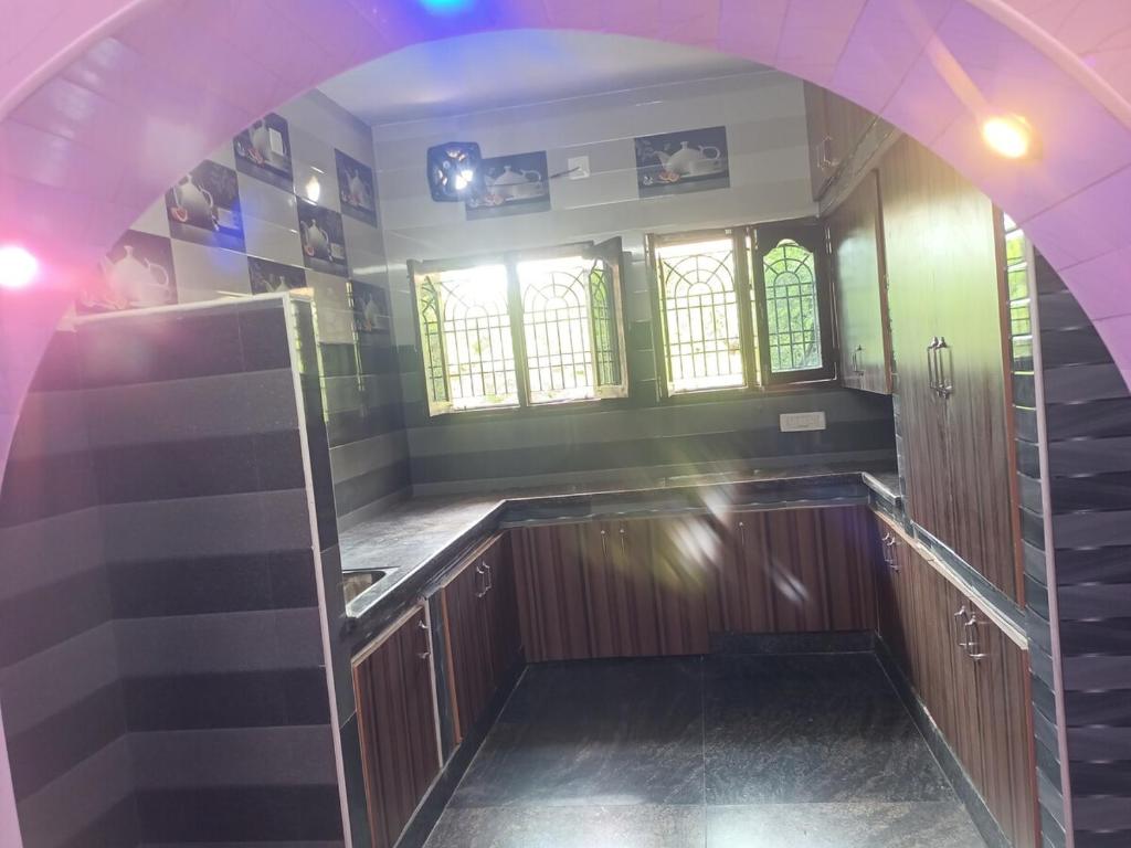 a kitchen with an archway in the middle of a room at Homestay Tirupati 2bhk near Alipiri kapilathertham in Tirupati