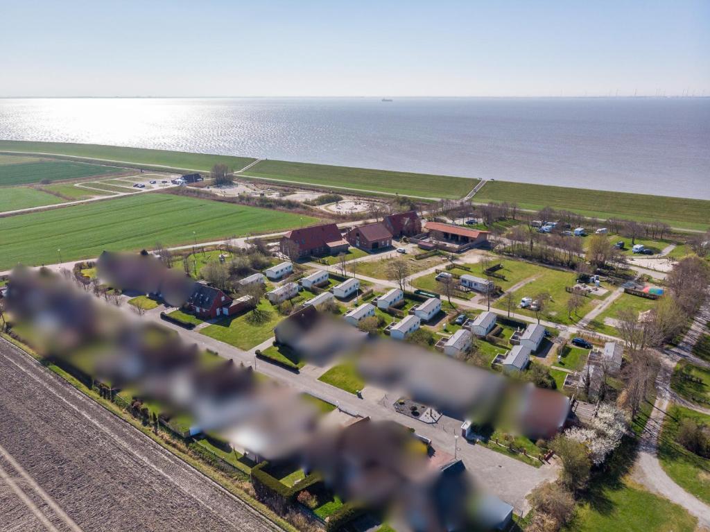 an aerial view of a village next to the ocean at Seewind in Krummhörn