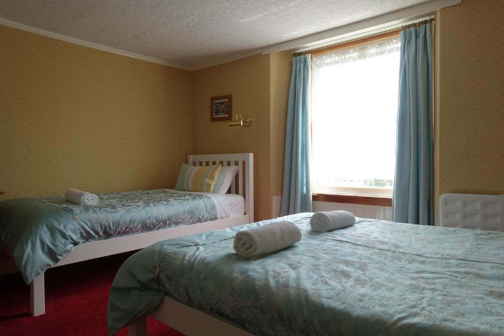 Postel nebo postele na pokoji v ubytování Ashgrove House